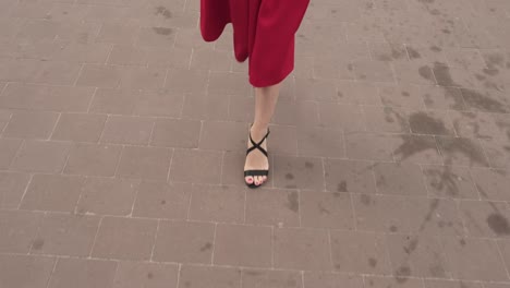 Pretty-girl-in-red-walks-down-the-street