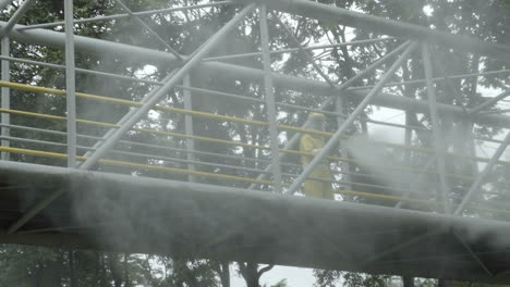 Official-worker-disinfecting-bridge-in-Bogota,-Colombia