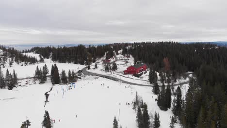 Trondheim's-Skistua-winter-cabin-in-snowy-winter-landscape,-aerial-view