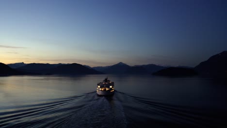 Aerial-view-of-Ferry-moving-through-water-at-Dusk