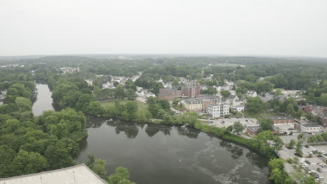 Aerial-Fly-Over-Drone-Footage-over-a-lake-in-Downtown-Westbrook-in-Maine,-Cumberland-County,-USA