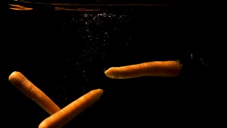 Three-Pieces-Of-Carrots-Submerged-Into-The-Clean-Water