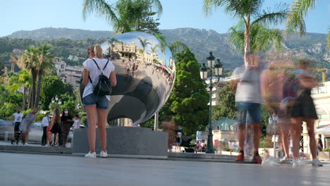 People-taking-selfie-at-the-mirror-sculpture-in-Grand-Casino-Square-in-Monaco,-Monte-Carlo,-France