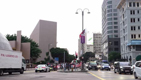 A-stationary-footage-at-the-center-of-a-heavy-traffic-in-a-road-junction-in-Tsim-Sha-Tsui,-Hong-Kong