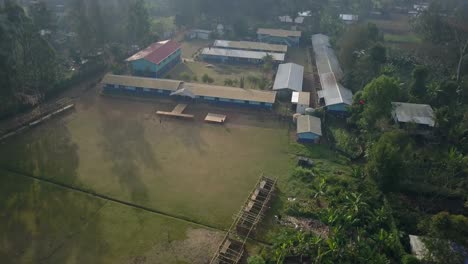 Aerial-view-moving-shot,-scenic-view-of-the-school-roof-and-landscape-in-Goroka,-Papua-New-Guinea