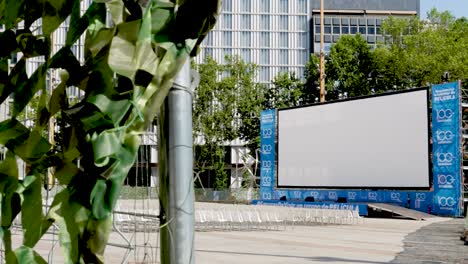 Summer-movie-threatre-screen-of-La-Estival-at-daytime-with-empty-chairs-in-Madrid,-Spain