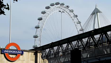 Looking-up-towards-London-Eye-from-the-Embankment-Station,-London