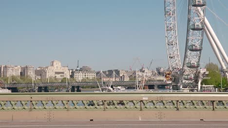 Bicycles-and-runners-on-empty-Westminster-bridge,-looking-towards-the-shut-down-London-Eye