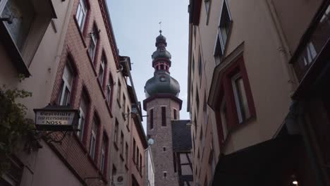 Walking-look-up-view-of-historic-buildings-and-church-in-Cochem-Germany-old-town