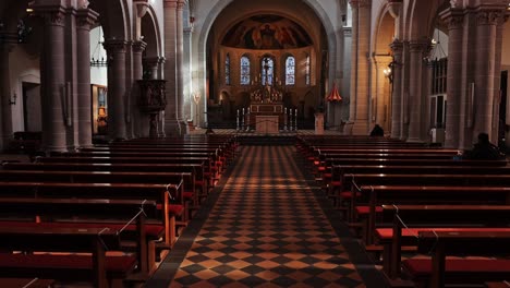 Tilt-up-view-of-the-church-interior-of-the-Basilica-of-St-castor-in-Koblenz-from-the-perfect-tilled-floor-and-pews-to-the-altar,-sanctuary-and-ceiling