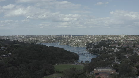 Drone-Volando-Por-El-Parque-Hacia-El-Puerto-De-Sydney-En-La-Bahía-Neutral