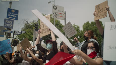 Protestors-holding-up-signs-saying-silence-is-violence-and-BLM-during-the-day-during-a-protest-by-City-Hall