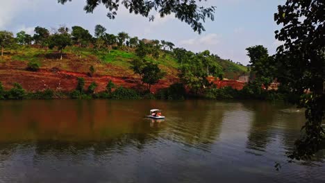 Wide-view-of-people-in-a-pedal-boat-on-a-beautiful-lake-in-Abuja,-Nigeria