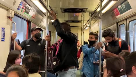 Subway-car-during-“the-new-normal”-post-covid-19-in-Mexico-City,-people-wearing-face-mask-in-subway