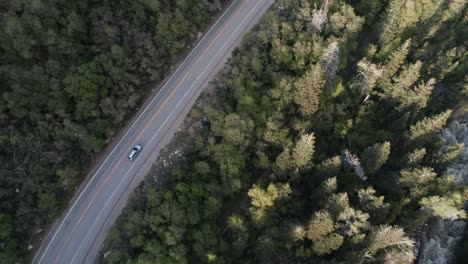 Tracking-car-shot-while-next-to-a-river,-coming-up-Big-Cottonwood-Canyon,-Utah