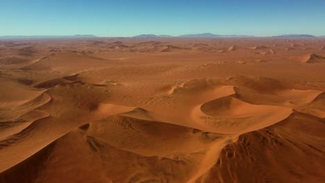 Drone-shot-of-the-Namib-desert-in-Namibia---drone-is-hovering-over-the-beautiful-red-desert-landscape