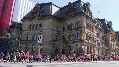 Hundreds-of-marathon-runners-run-through-the-streets-of-Ottawa-Canada,-Wide-Shot