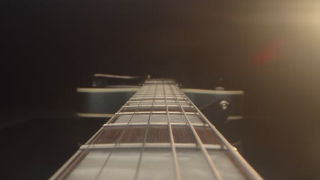 Push-in-macro-along-the-fretboard-of-an-electric-guitar