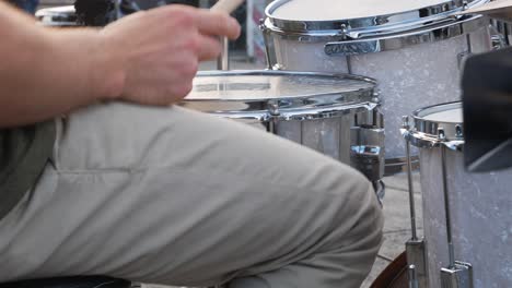 Drummer-ends-performance,-and-lays-down-his-drumsticks-on-snare-drum-to-stand-for-final-bow