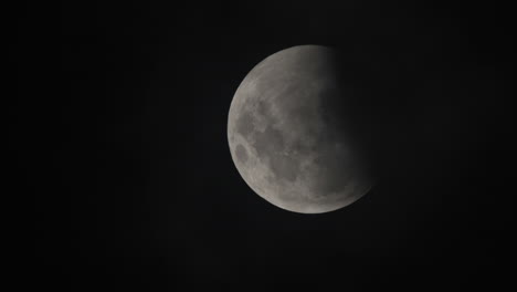 Close-up-shot-of-the-moon-in-the-nights-sky-during-a-lunar-eclipse,-complete-black-sky