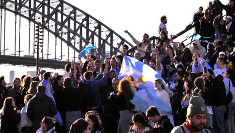 Close-shot-of-Argentina-soccer-fans-celebrating-the-16th-Copa-America-win-on-the-steps-of-the-Opera-House,-Sydney,-Australia