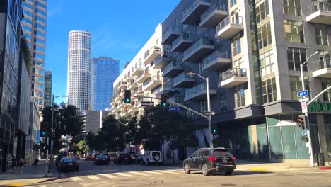 Downtown-Los-Angeles-on-Hot-Sunny-Day,-Traffic-on-8th-Street,-People-and-Buildings,-California-USA