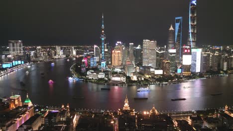 Aerial-Drone-fly-night-city-downtown-banks-of-the-Huangpu-River,-Shaghai-China