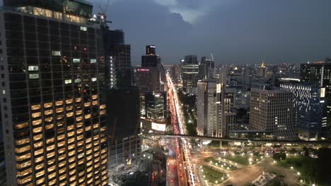 City-Lights-and-Traffic-of-Bangkok:-Aerial-Drone-Flyover-at-Night,-Thailand