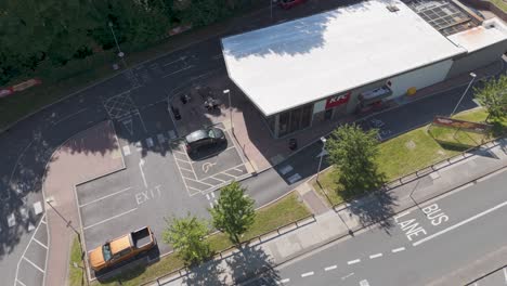 Drone-exterior-view-of-a-KFC-drive-through-restaurant-with-adjacent-parking-and-roads-in-Plymouth,-UK