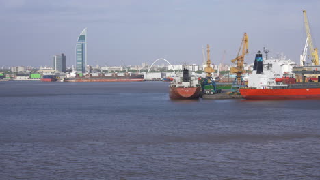 Montevideo-Uruguay-Port-and-Waterfront,-Cargo-Boats,-Cranes-and-Buildings,-Offshore-View