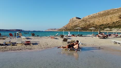 Relaxing-Romantic-Couple-on-Idyllic-Balos-Beach-Lagoon,-Crete,-Greece,-Slowmotion