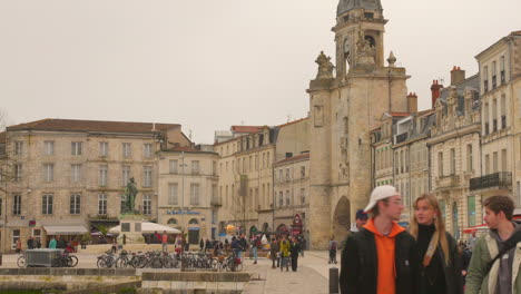 Historic-buildings-and-clock-tower-in-La-Rochelle's-old-town-on-a-cloudy-day