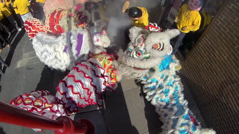 High-angle-view-of-Chinese-lions-and-masked-revelers-during-Chinese-New-Year-celebration