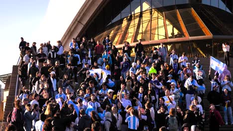 Close-shot-of-Argentinian-soccer-fans-celebrating-the-16th-Copa-America-win-on-the-steps-of-the-Opera-House,-Sydney,-Australia