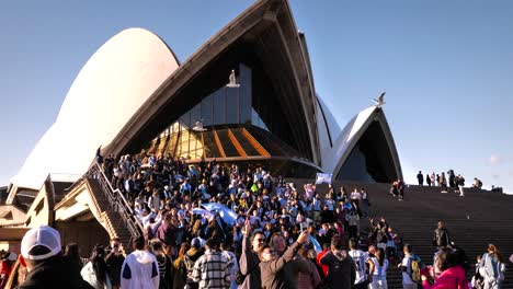 Primer-Plano-De-Aficionados-Al-Fútbol-Argentino-Celebrando-La-16ª-Victoria-En-La-Copa-América-En-Las-Escaleras-De-La-Ópera-De-Sydney,-Australia.