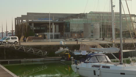 La-Rochelle-Aquarium-with-boats-docked-nearby,-sunny-day,-calm-atmosphere