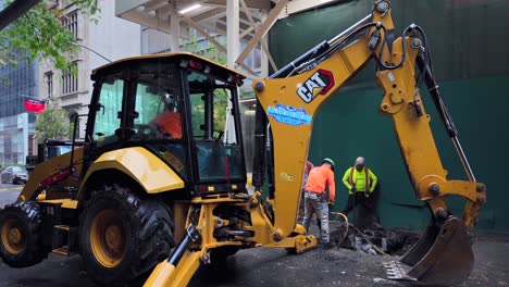 A-street-view-of-men-digging-a-hole-on-a-street-in-NYC-on-a-rainy-day