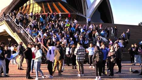 Wide-shot-of-Argentina-soccer-fans-celebrating-the-16th-Copa-America-win-on-the-steps-of-the-Opera-House,-Sydney,-Australia