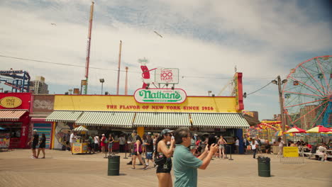 Hot-dog-restaurant-on-the-boardwalk-in-Coney-Island-during-summer,-New-York-US