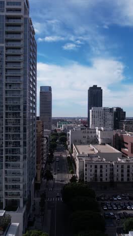 Los-Angeles-USA,-Vertical-Aerial-of-Traffic-in-South-Park,-Buildings-and-Streets,-Drone-Shot