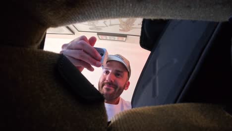 Man-looking-for-action-camera-finds-it-looking-down-into-furniture