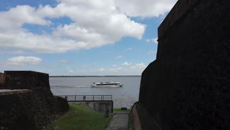 Boat-passing-on-Amazon-River,-viewed-from-Forte-do-Presépio,-Belém,-Brazil