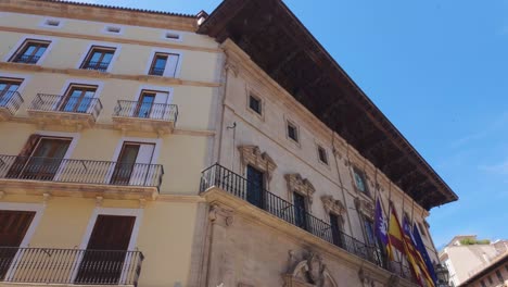 Spanish-building-with-Spain,-Catalonia-and-European-union-flag-in-Palma-de-Mallorca