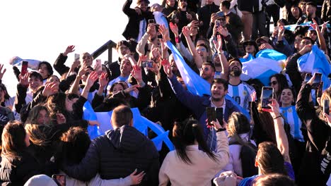 Close-shot-of-Argentina-soccer-fans-celebrating-the-16th-Copa-America-win-on-the-steps-of-the-Opera-House,-Sydney,-Australia