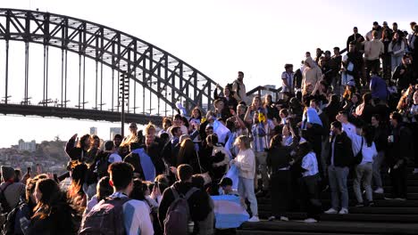 Wide-shot-of-Argentina-soccer-fans-celebrating-the-16th-Copa-America-win-on-the-steps-of-the-Opera-House,-Sydney,-Australia