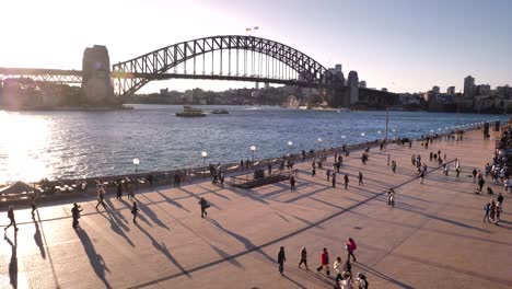 Handheld-footage-of-Sydney-Harbour-Bridge-viewed-from-next-to-the-Opera-House-with-people-in-the-foreground