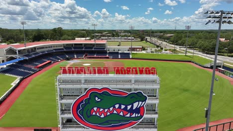 Aerial-flyover-baseball-Stadium-of-Florida-Gators-with-crocodile-logo-during-sunny-day-in-Gainesville,-USA