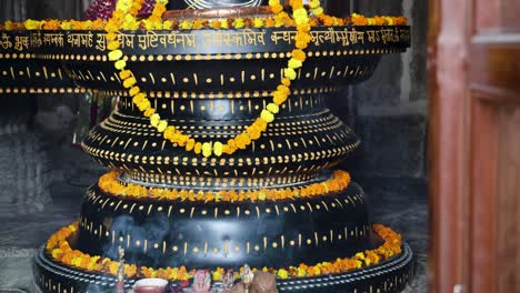 Der-Hinduistische-Religiöse-Gott-Shiva-Shivalinga-Ist-Aus-Verschiedenen-Blickwinkeln-Mit-Blumen-Geschmückt.-Das-Video-Im-Alten-Tempel-Wurde-In-Der-Kumbhal-Festung-Kumbhalgarh-In-Rajasthan,-Indien,-Aufgenommen.