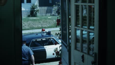 1960s-POLICE-OFFICER-LEAVING-HOUSE-HEADED-TO-HIS-SQUAD-CAR