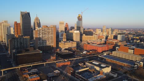 Downtown-Detroit,-Michigan,-USA-in-aerial-dolly-in-view-during-golden-hour-sunlight